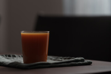 Pumpkin carrot juice mix in a glass on wood table