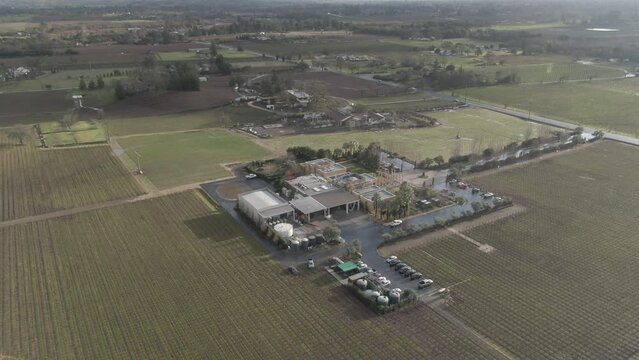 Aerial above commercial winery and vineyard in Napa Valley, California