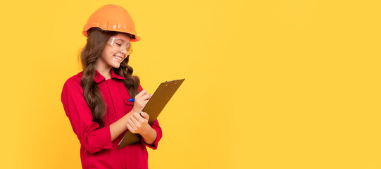 happy teenager girl in protective eyeglasses and helmet hold document folder, making notes. Child builder in helmet horizontal poster design. Banner header, copy space.