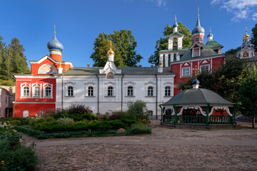 Fototapeta na wymiar Sretensky and Annunciation Churches, the Great Bell Tower, the sacristy and the holy well of the Holy Dormition Pskov-Pechersk Monastery on a sunny summer day, Pechory, Pskov region, Russia