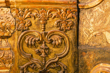 Background of a gilded wooden iconostasis made in the 16th century. The ancient carved iconostasis of the 16th century in Perm is decorated with patterns, images of animals and angels.Religious images