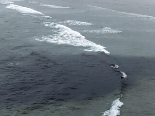 Grey waters, top view, full frame. Seascape. The surface of the water as a background. Aerial view of Ocean