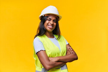 Positive young lady crossed arms, beaming smile wear protective equipment isolated yellow background