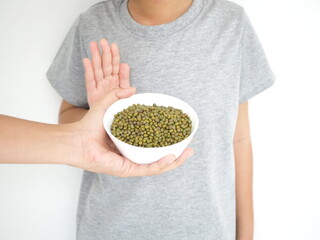 Kid boy refusing to eat green beans, Food allergy concept. Closeup photo, blurred.