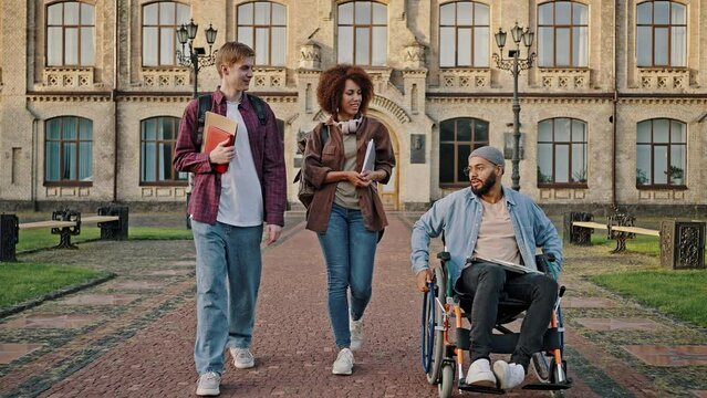 Multiracial students discuss classes walking on road