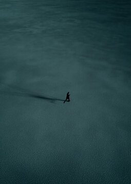Man in black suit runs in desert at twilight. Aerial view. 3D render.