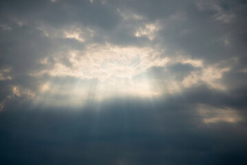 The sun shines through the clouds