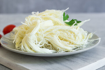 Turkish traditional homemade checil or string cheese on plate, healthy dairy product