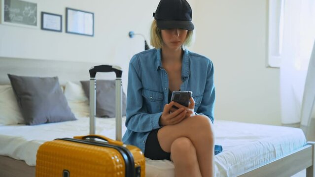 Teenage girl got ready before everyone else and is waiting to go on vacation.