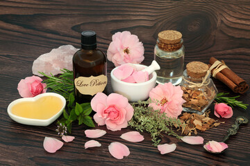 Romantic love potion magic spell and aphrodisiac ingredients with herbs, rose flowers, honey,...