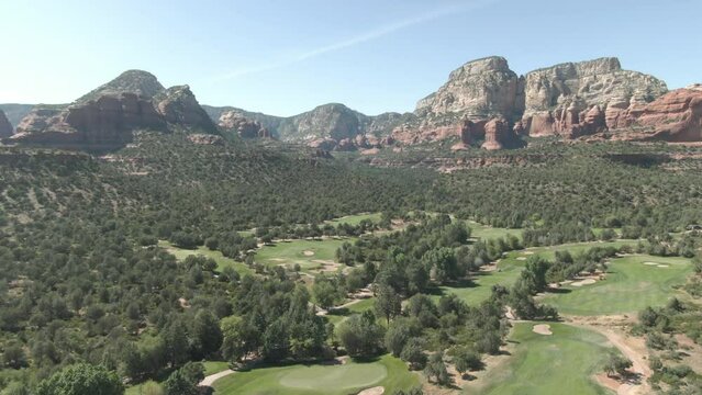 Wide Aerial Of Sedona Golf Course With Red Cliffs In Background