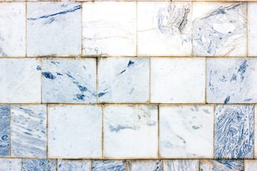 Blue and gray vintage marble ceramic tile textured background on the old building stone brick wall close up.