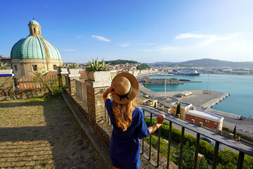 Tourism in Ancona, Italy. Back view of traveler woman enjoying view of Ancona city and seaport from...