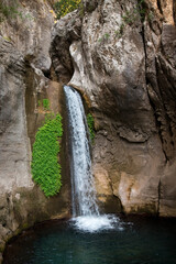 Travel and sighseeing concept. Beautiful waterfall and natural pool with pristine turquoise water in Sapadere canyon in Alanya, Turkey.