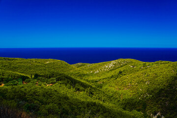 Fototapeta premium green hills with blue sea and sky