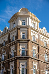 Fototapeta na wymiar Traditional brick architecture of buildings in London, the UK's grand capital.