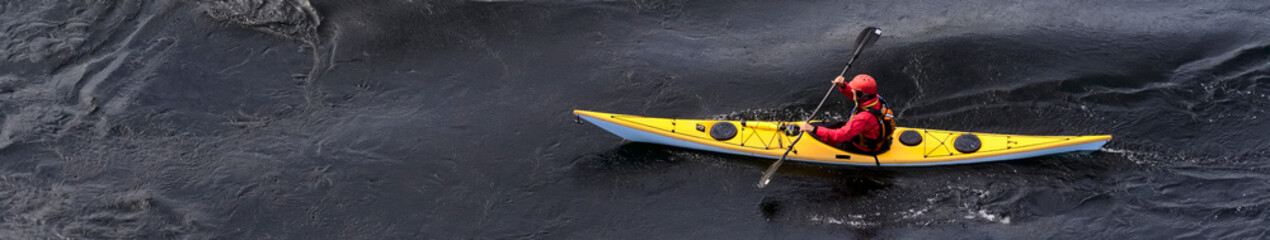 Blue and yellow kayak on open water at Loch Lomond