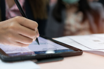 Businesswoman writing stylus pen note on digital tablet computer for E-learning education online...