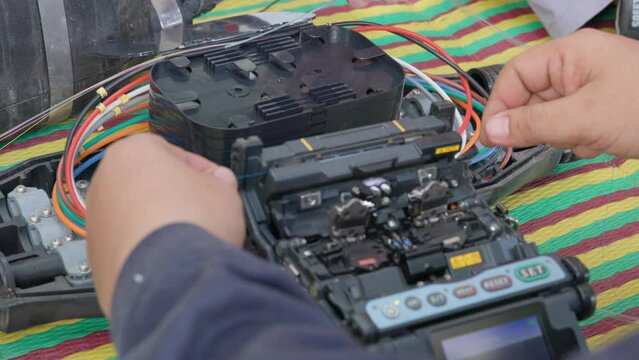 Fusion of Fiber Optics Cable Internet signal splicing and wire connection using equipment, optical line welding machine Optic fiber soldering ISP engineer