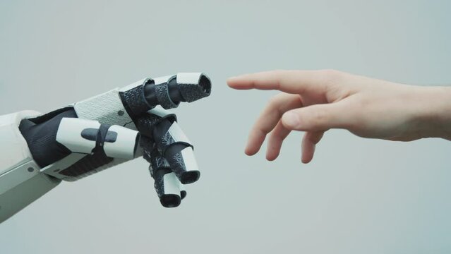 Robot hand and human hand touching each others on white background. Machine. Cooperation. Modern technology. Close-up. Idea. Future lifestyle concept. Software. Cyborg, automation. Robotic assistant