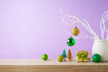 Christmas holiday background with gift box and  decoration on wooden table over purple background. Winter greeting card design