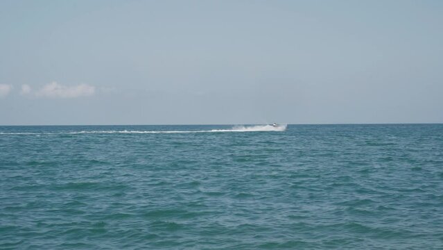 A man rides a jet ski on the surface of the sea. The concept of entertainment and recreation.