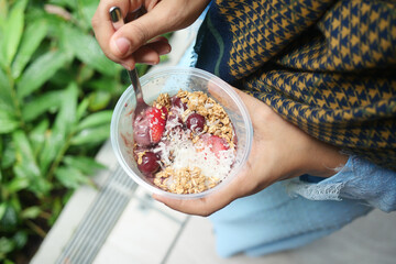 women holding a bowl of breakfast cereal on table 