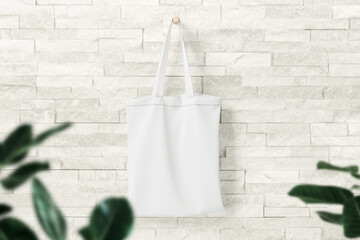 Clean minimal bag canvas hanging mockup on the wall with leaves