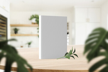 Clean minimal photo book 5.5x8.5 mockup standing on top table with vase