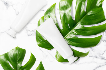 Clean minimal cream tube packaging mockup on leaf background