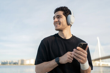 A runner trains active fast running in the city with headphones.