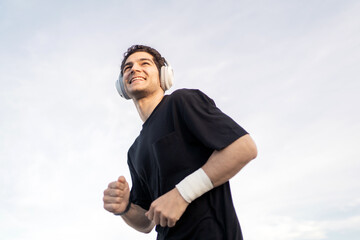 Male athlete training in the city. Uses a fitness watch