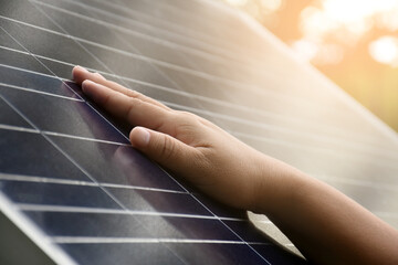 Closeup hand on photovoltaic or solar cell panel, soft and selective focus on hand, self...