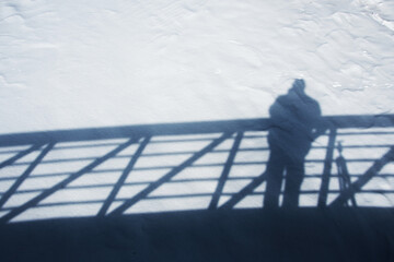 Shadow of a person on a bridge