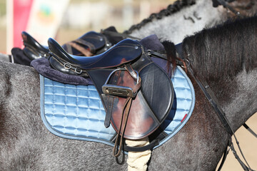 Fototapeta na wymiar Close up of a sport horse saddle. Quality classical leather saddle