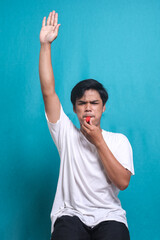 Football referee raising hand and blowing whistle