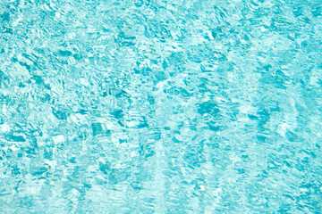 turquoise color backdrop of swimming pool water with ripples. concept of summer