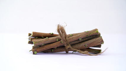 Medicinal neem twigs. Herbal neem leaves and branch over white background. Azadirachta indica - A branch of neem tree leaves. Natural Medicine.