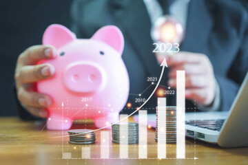 saving energy and money concept. idea for save or investment.businessman holding lightbulb beside piggy bank for saving money wealth saving money coins on table concept financial.