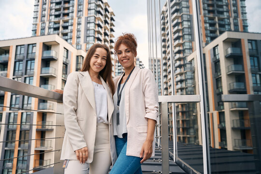 Smiling confident businesswomen posing for camera outdoors