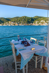 Reserved table in Greek tavern in Vathy in the picturesque port of Vathy village, the capital of Ithaca island, Ionian, Greece.