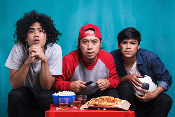 Supporters worrying about favorite football team. Soccer fans watching game in disbelief while their team losing the match.