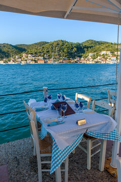 Reserved table in Greek tavern in Vathy in the picturesque port of Vathy village, the capital of Ithaca island, Ionian, Greece.