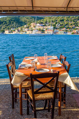 Reserved table in Greek tavern in Vathy in the picturesque port of Vathy village, the capital of Ithaca island, Ionian, Greece.