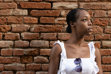 Portrait of African American woman dressed in white getting to know Europe, Ferrara. Italy