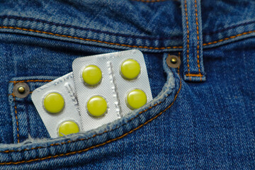 Pills in the Jeans Pocket. Close-Up Of Medicines In Pocket Of Jeans