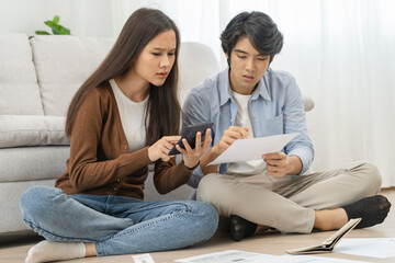 Stressed financial owe asian young couple love sitting suffer, stressed and confused by calculate...
