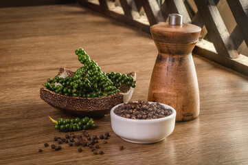 Black peppercorn on wooden floor