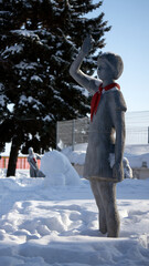 Sculptures of Soviet pioneers in the winter park. The history of pioneering in frozen sculptures.