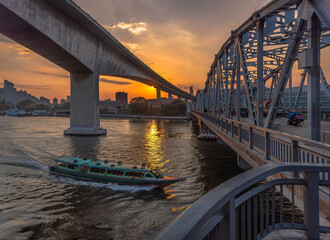 picture of Chao Phraya passenger boat is passing under the Bangkok Bridge and Rama 3 Bridge in the morning of the start of the working day